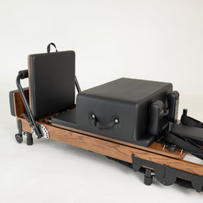 Pilates reformer machine on a white background